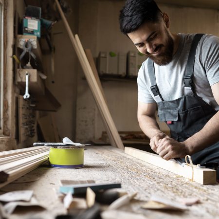 carpenter-cutting-mdf-board-inside-workshop
